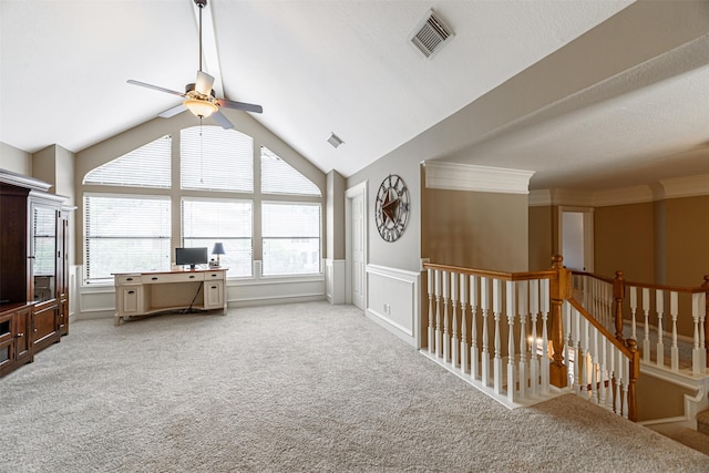 interior space with crown molding, light colored carpet, lofted ceiling, and ceiling fan