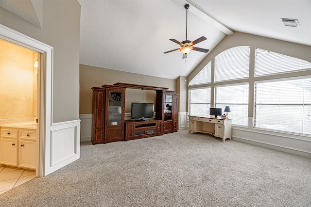 unfurnished living room featuring beamed ceiling, high vaulted ceiling, light colored carpet, and ceiling fan