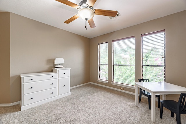 interior space with light carpet and ceiling fan