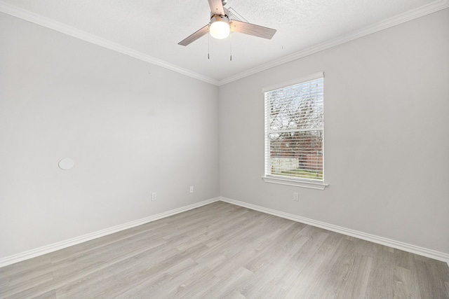 spare room featuring a textured ceiling, ornamental molding, light hardwood / wood-style floors, and ceiling fan