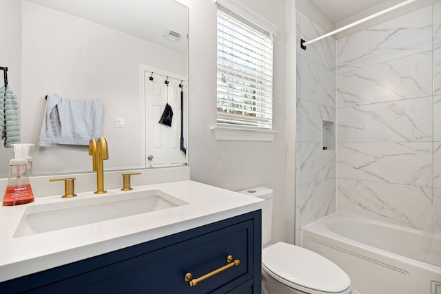 full bathroom featuring vanity, toilet, and tiled shower / bath combo