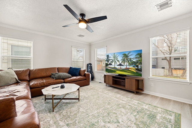 living room with ornamental molding, a textured ceiling, ceiling fan, and light hardwood / wood-style floors