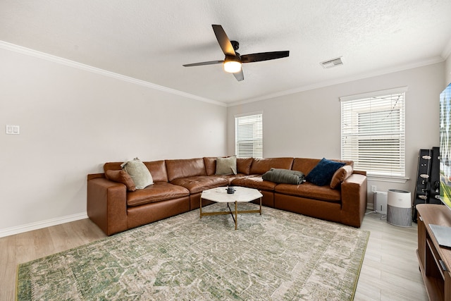 living room with ceiling fan, crown molding, light hardwood / wood-style floors, and a textured ceiling