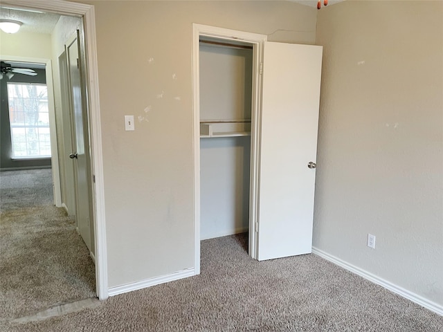 unfurnished bedroom featuring carpet flooring and a closet