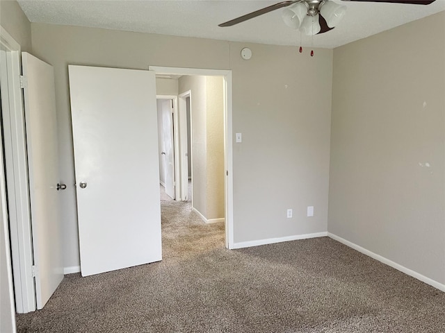 unfurnished bedroom featuring carpet and ceiling fan