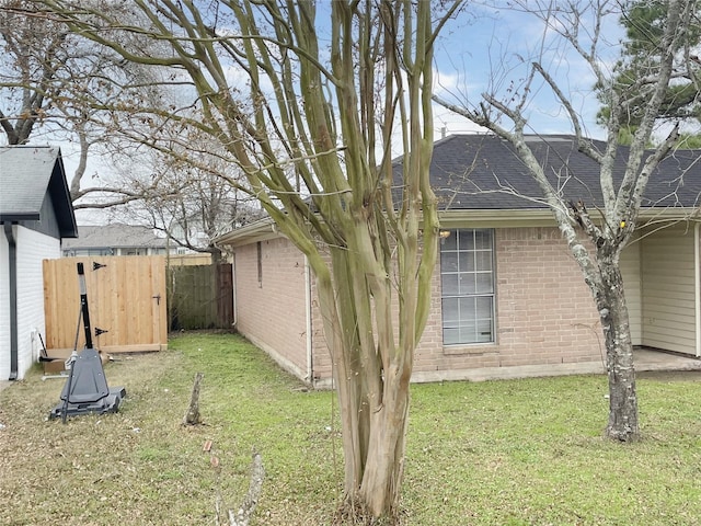 view of side of home featuring a lawn