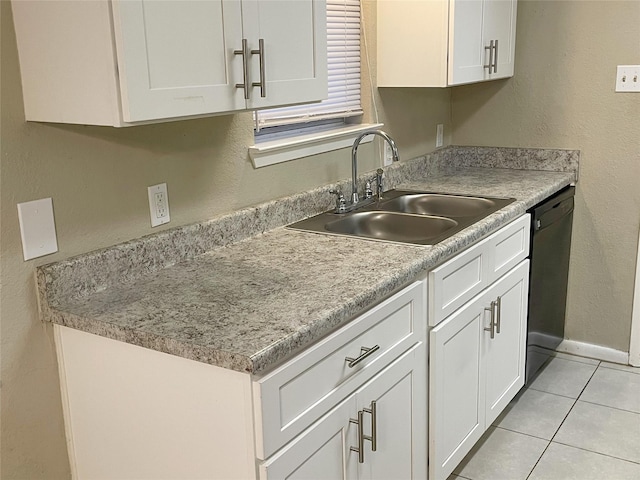 kitchen featuring sink, light tile patterned floors, white cabinets, and dishwasher