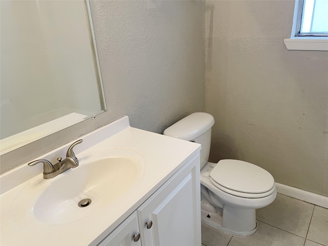 bathroom featuring vanity, toilet, and tile patterned flooring