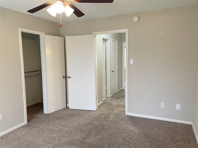 unfurnished bedroom featuring light carpet, a textured ceiling, ceiling fan, and a closet