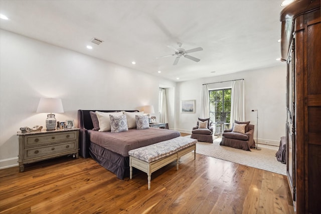 bedroom with hardwood / wood-style floors, access to outside, and ceiling fan