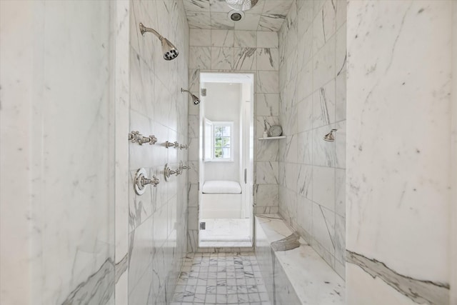 bathroom with tiled shower