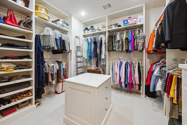 walk in closet featuring light carpet