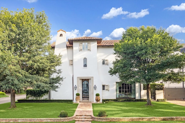 mediterranean / spanish-style home with a front yard