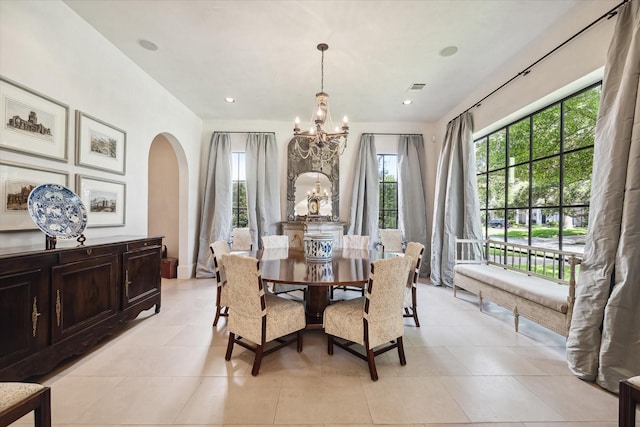 tiled dining space featuring an inviting chandelier