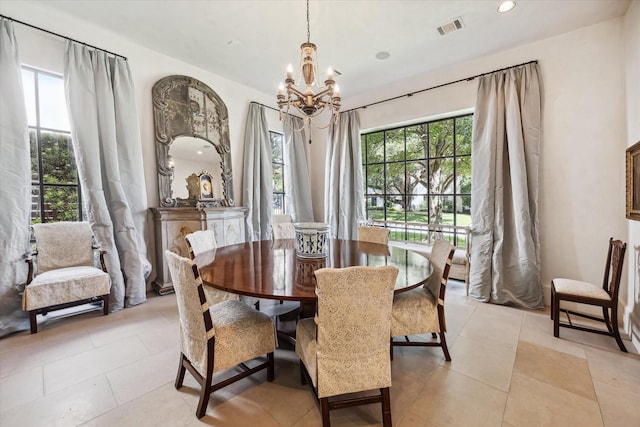 dining space featuring an inviting chandelier and light tile patterned floors