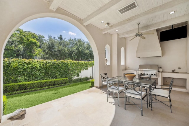 view of patio / terrace featuring ceiling fan, an outdoor kitchen, and area for grilling