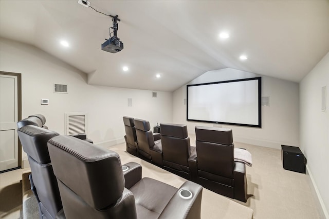 carpeted cinema room with vaulted ceiling