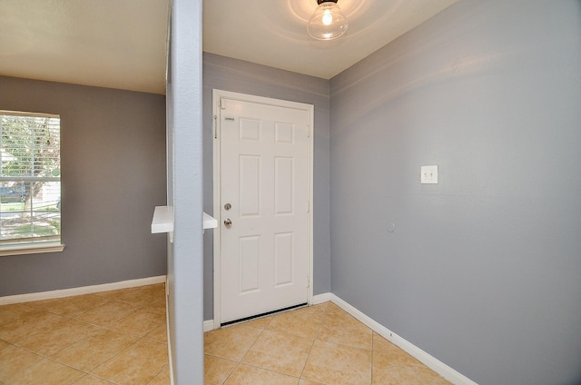 doorway with light tile patterned floors