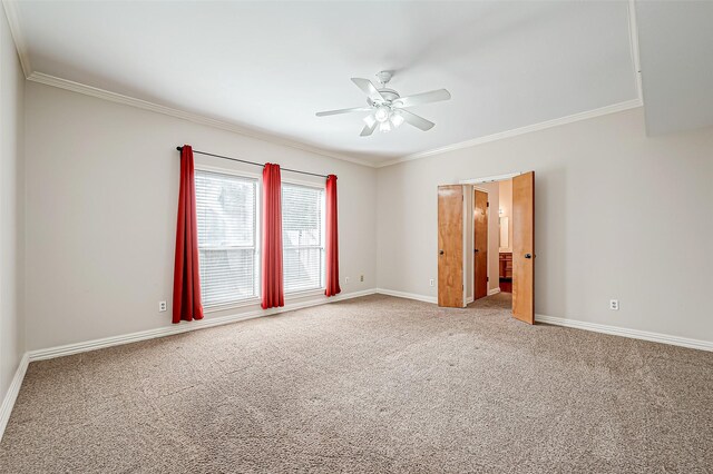 spare room featuring ceiling fan, ornamental molding, and carpet