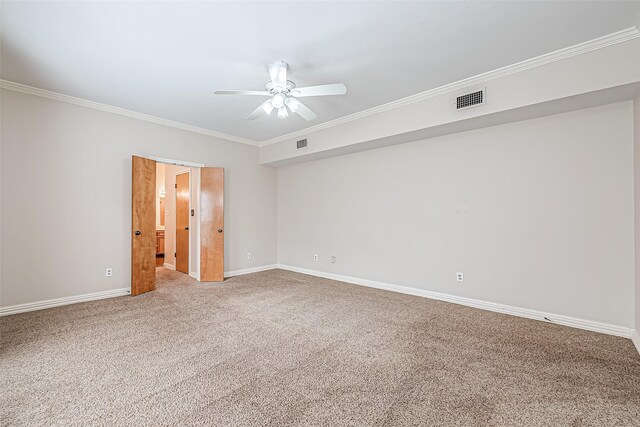 unfurnished room featuring carpet floors, ornamental molding, and ceiling fan