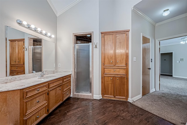 bathroom with ornamental molding, a shower with door, and wood-type flooring