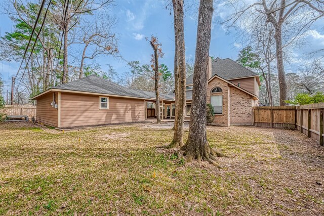 rear view of house featuring a yard