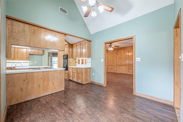 kitchen with ceiling fan, high vaulted ceiling, black double oven, dark hardwood / wood-style flooring, and kitchen peninsula