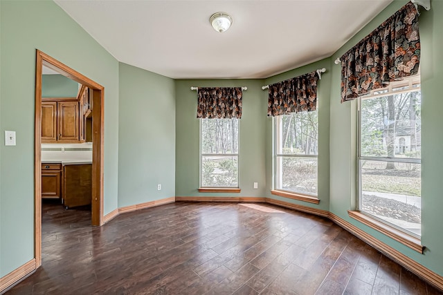 empty room with dark hardwood / wood-style floors