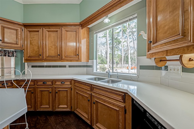 kitchen featuring sink, decorative backsplash, dark wood-type flooring, and black dishwasher