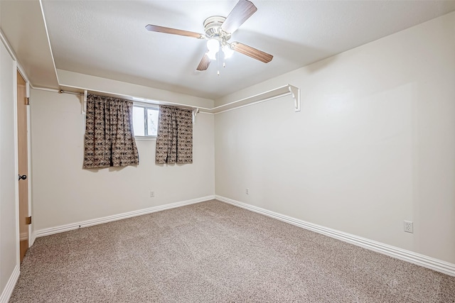 empty room with ceiling fan and carpet flooring