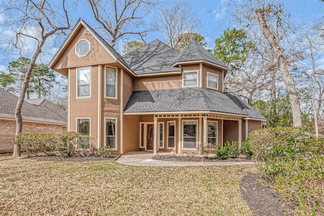 rear view of house featuring a lawn