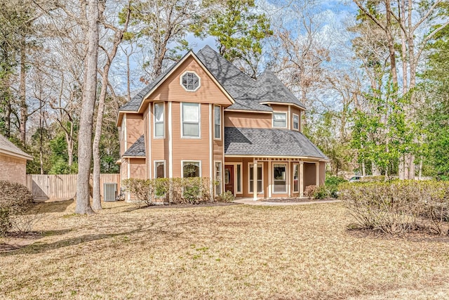 back of property featuring central AC unit and a lawn