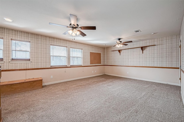 carpeted spare room featuring ceiling fan