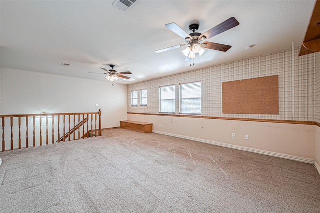 carpeted spare room featuring ceiling fan