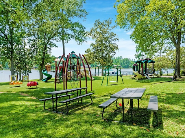 view of community featuring a playground and a lawn