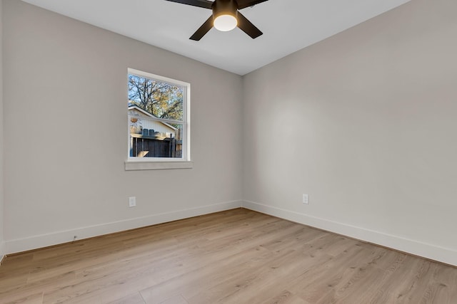 spare room featuring light wood-style floors, baseboards, and a ceiling fan