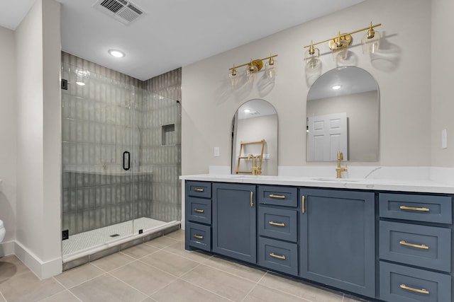 full bath featuring a sink, visible vents, a shower stall, tile patterned floors, and double vanity