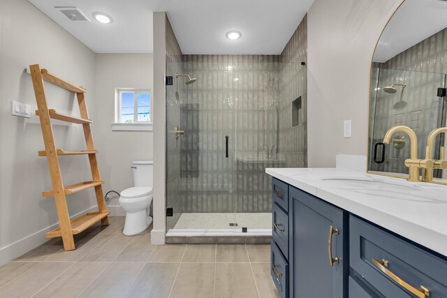 bathroom with tile patterned flooring, vanity, a shower with shower door, and toilet