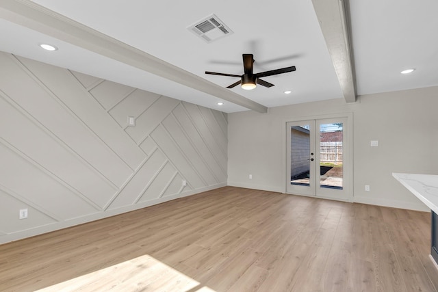 unfurnished living room with ceiling fan, light hardwood / wood-style flooring, french doors, and beamed ceiling