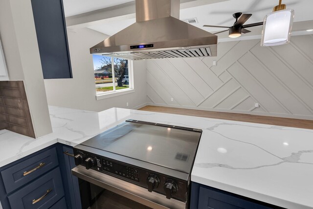 kitchen featuring light stone counters, island range hood, range with electric stovetop, and blue cabinets