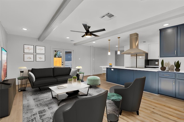 living area featuring ceiling fan, recessed lighting, visible vents, light wood-type flooring, and beamed ceiling