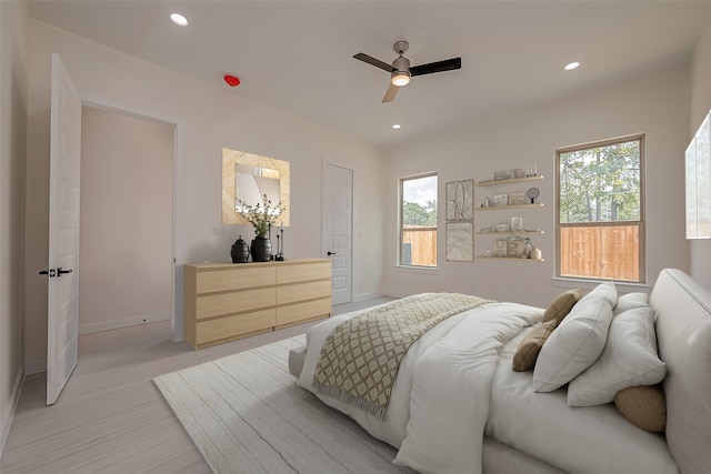 bedroom with ceiling fan and light hardwood / wood-style flooring