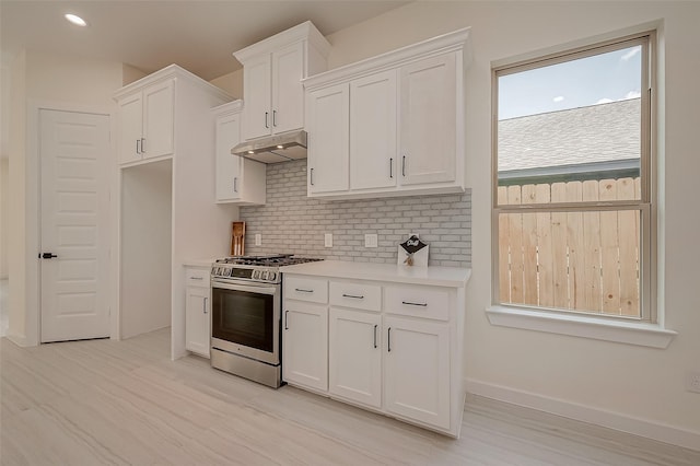 kitchen with white cabinetry, decorative backsplash, stainless steel range with gas cooktop, and light hardwood / wood-style floors