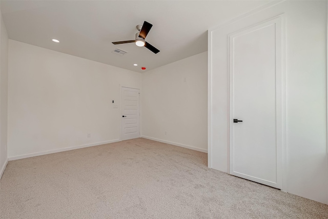 unfurnished room with light carpet and ceiling fan