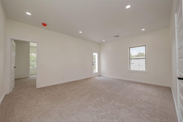 carpeted empty room with a wealth of natural light