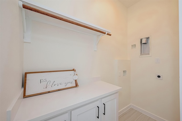 washroom featuring cabinets and hookup for an electric dryer