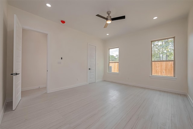 empty room with ceiling fan and light wood-type flooring