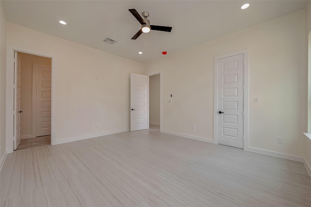 spare room featuring ceiling fan and light hardwood / wood-style flooring