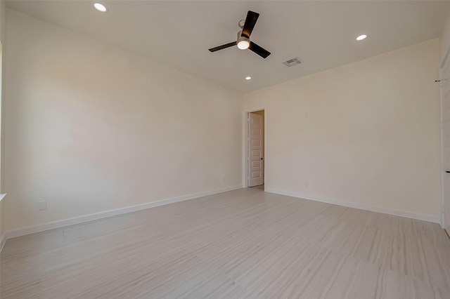 empty room featuring ceiling fan and light hardwood / wood-style floors