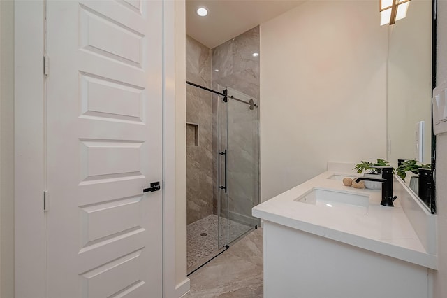 bathroom with an enclosed shower and vanity